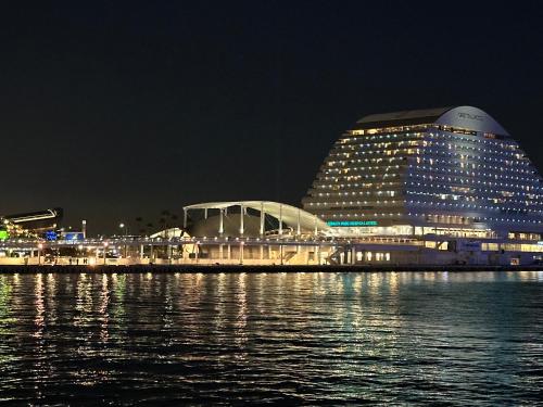 a building next to the water at night at Private Inn Bambee in Kobe