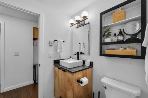a bathroom with a sink and a mirror at Three Rivers Basecamp - Meredith Lodging in Sunriver