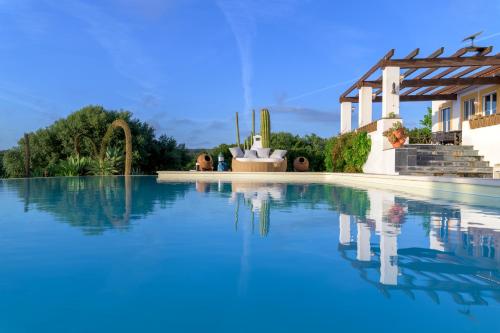 a swimming pool in front of a house at Monte da Casa Telhada in Santiago do Cacém