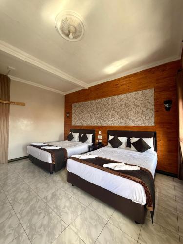 a hotel room with two beds in a room at Parama Bromo Hotel in Ngadisari