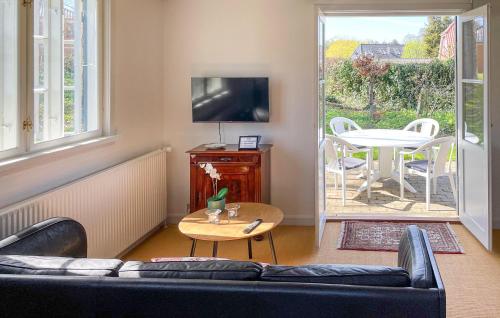 a living room with a couch and a table at Nice Home In Ry With Wifi in Ry