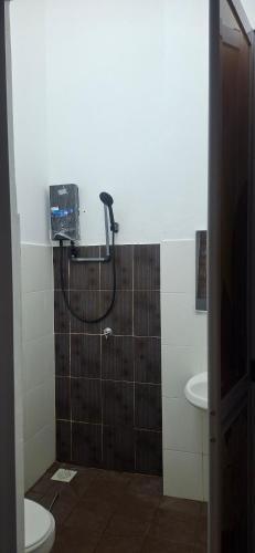 a bathroom with a shower with a toilet and a sink at Twenty2 Homestay Sepang in Sepang