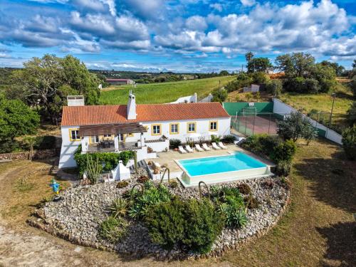 an aerial view of a house with a swimming pool at Monte da Casa Telhada in Santiago do Cacém