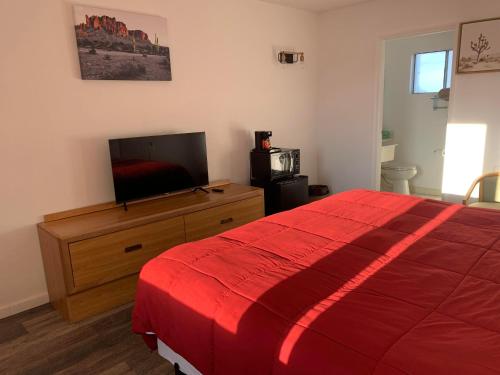 a bedroom with a bed and a flat screen tv at Almara Inn in Tucumcari
