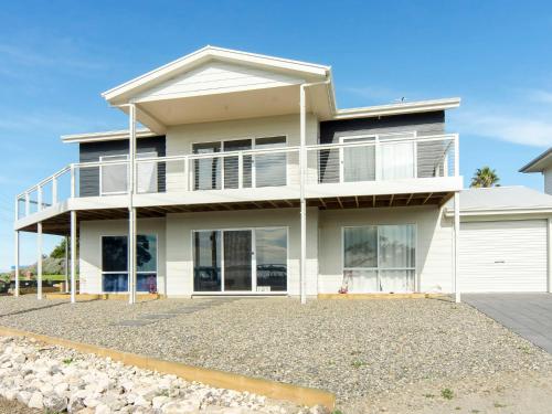 a large white house with a balcony at Riverside Dream - 109 Barrage Rd in Goolwa South