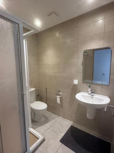 a bathroom with a toilet and a sink at Luxury Apartment in martil in Martil