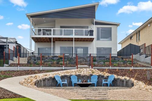 a group of chairs sitting in a fountain in front of a house at Lagoon Views in Hindmarsh Island