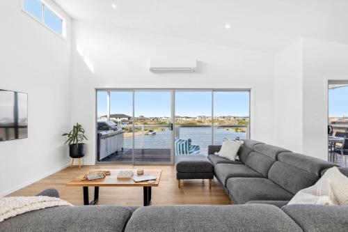 a living room with a couch and a table at Lagoon Views in Hindmarsh Island