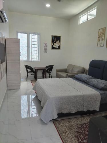 a bedroom with a bed and a living room at Makwan Homestay D in Kubang Semang