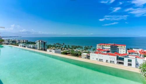 a view of the ocean from a resort infinity pool at Maralma Bucerias 1 half Blocks from Beach Sleeps 4 in Bucerías