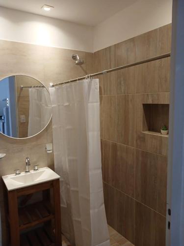 a bathroom with a shower and a sink and a mirror at Listo para vos in RSA
