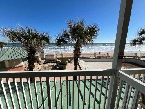 a view of the beach from the balcony of a resort at Oceanfront 1BR Condo Daytona Resort Pool Access in Daytona Beach