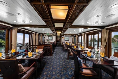 a dining car of a train with tables and chairs at Halong Luxury Cruise in Ha Long