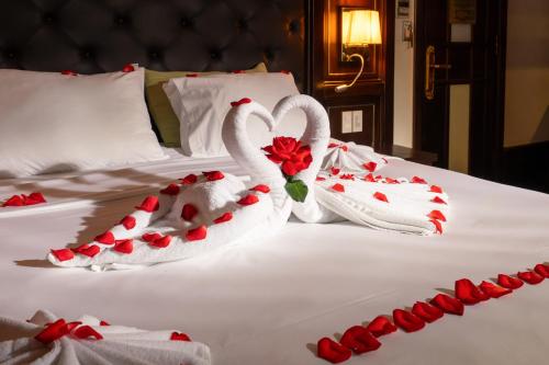 two swans made out of towels on a bed at Halong Luxury Cruise in Ha Long