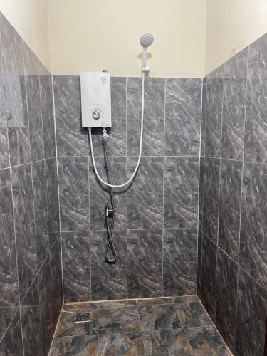 a shower with a shower head in a bathroom at Authentic Joe homestay in Siem Reap