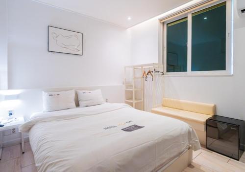 a hospital room with a bed and a tv at Hotel YAM Yeosu Hakdong in Yeosu
