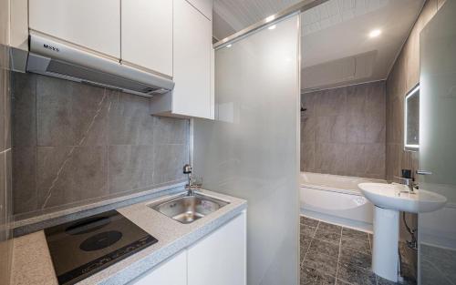 a small white bathroom with a sink and a sink at Incheon The Rest Hotel in Incheon