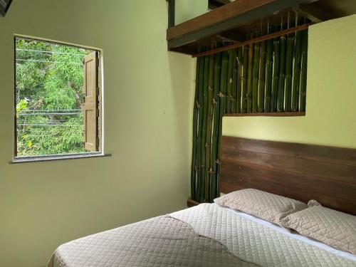 a bedroom with a bed and a window at Casa Sankofa de Belém in Belém