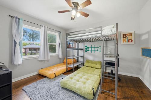 a living room with a bunk bed and a couch at Escape by Beaches & Blue Angels in Pensacola