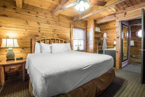 a bedroom with a bed in a log cabin at Hilton Grand Vacations Christmas Mountain Village Wisconsin in Wisconsin Dells