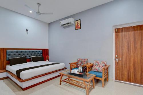a bedroom with a bed and a table and a chair at Super Hotel O Greater Noida West Link Road Formerly Advent in Noida