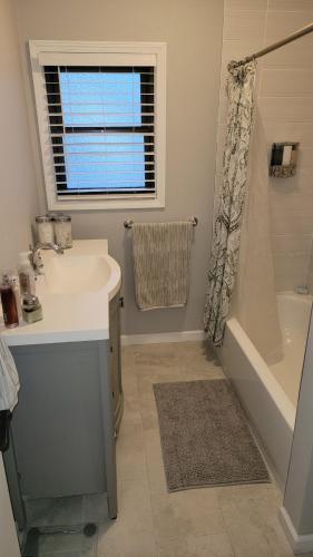 a bathroom with a sink and a tub and a shower at Secluded Chalet in Harrison
