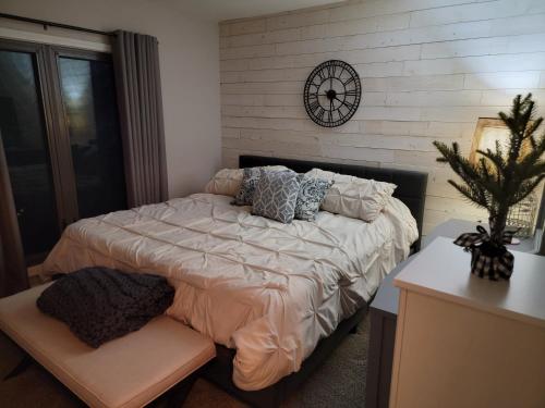 a bedroom with a bed with a clock on the wall at Secluded Chalet in Harrison