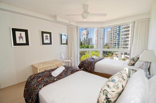 a bedroom with two beds and a window at Ocean Sands Resort in Gold Coast