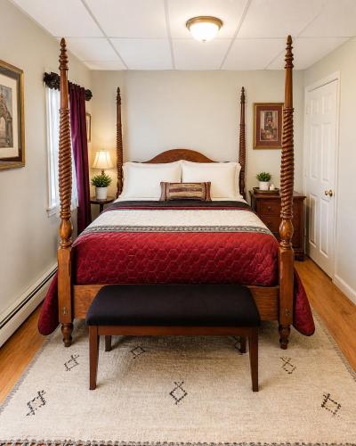 a bedroom with a bed with a red bedspread at Fall River Stay Stylish 2BR Urban Haven Suite in Fall River