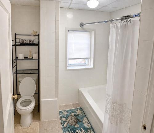 a bathroom with a toilet and a bath tub at Fall River Stay Stylish 2BR Urban Haven Suite in Fall River