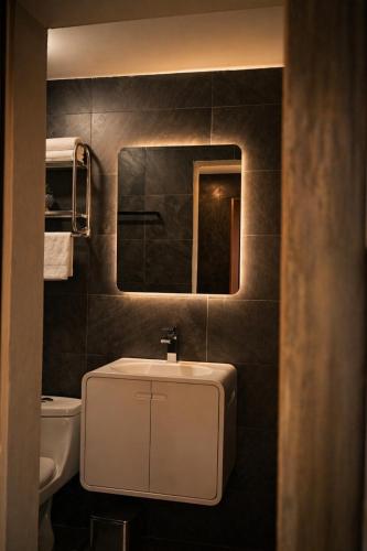 a bathroom with a sink and a mirror at Santa Martha Hotel Boutique in Progreso de Obregón