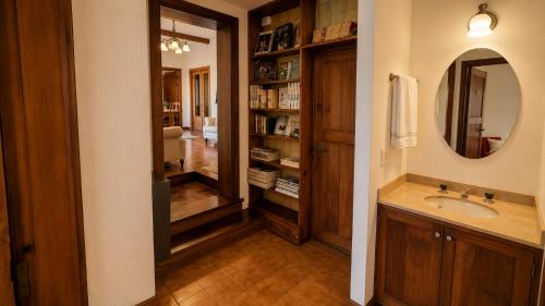 a bathroom with a sink and a mirror at Centrally located lakefront house in San Carlos de Bariloche