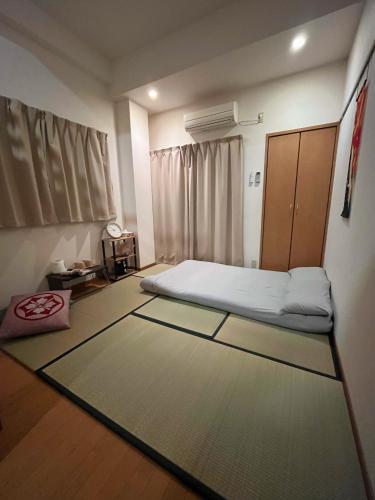 a bedroom with a bed and a cabinet in it at 一心館sakura401 in Wada