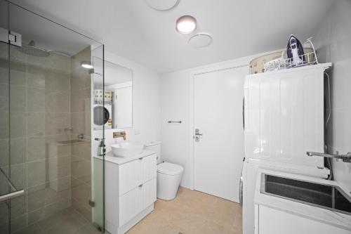 a bathroom with a shower and a toilet and a sink at The Lookout in Diamond Beach