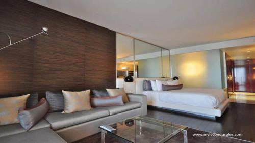 a living room with a couch and a bed at Palms Place No Resort fees with Balcony in Las Vegas