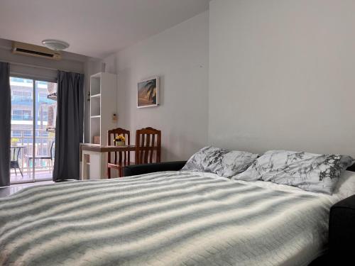 a bedroom with a bed and a view of a balcony at Mae Phim beach in Ban Tha Fat