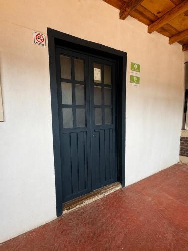 a black door on the side of a building at Hotel Mary o in Valle de Bravo