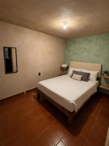 a bedroom with a large white bed in a room at Hotel Mary o in Valle de Bravo