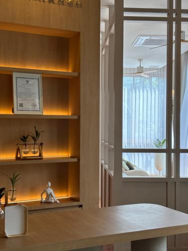 a kitchen with a table and a window at Amphawa Nanon Hotel in Amphawa