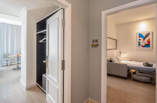 a room with a bed and a room with a door at INNSiDE by Meliá Madrid Gran Vía in Madrid