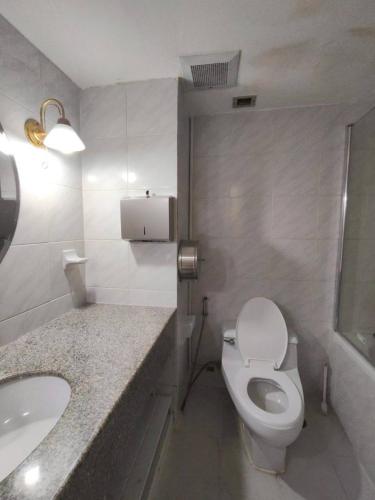 a white bathroom with a toilet and a sink at omni1818 in Bang Kapi