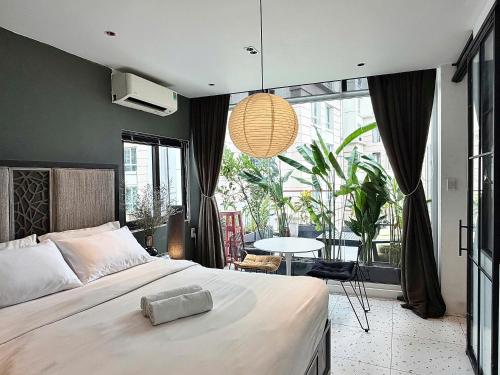a bedroom with a large bed and a large window at Jazz Living - Tropical Apartment 5 minutes walk from landmark 81 in Ho Chi Minh City