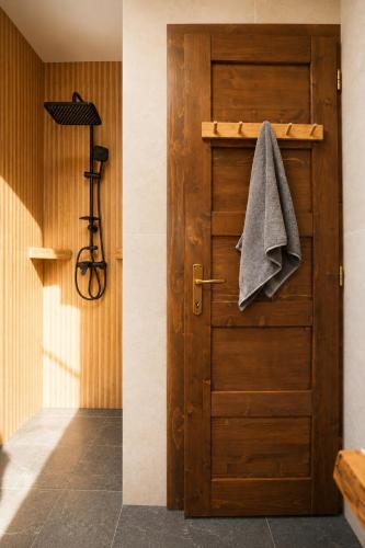 a wooden door with a towel hanging on it at Lunor House in Izvoare