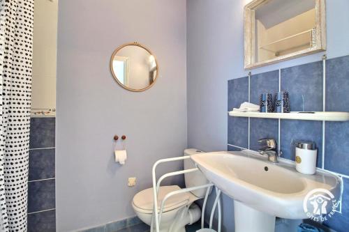 a bathroom with a sink and a toilet and a mirror at Chambres d'hôtes de botconan in Baden