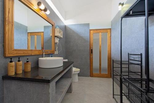 a bathroom with a sink and a mirror at KyGunAya Villa in Gili Islands