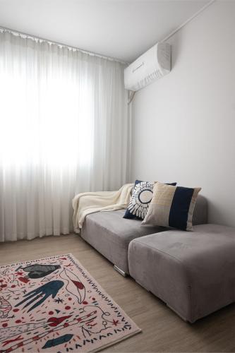 a bedroom with a bed and a rug and a window at 서울역 2분거리, 클레어맨션 201 in Samgong