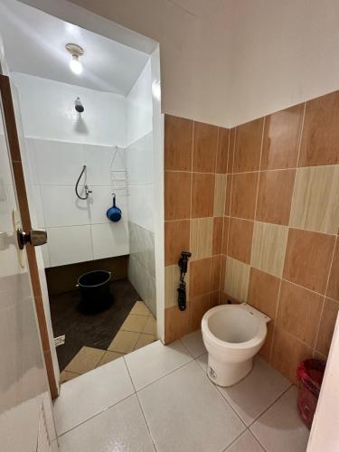 ein Badezimmer mit Toilette und Dusche in der Unterkunft Don Pedro shared bathroom in Tacloban