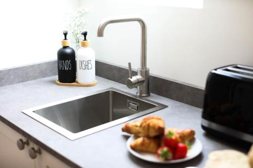 a sink with a plate of food and a plate of bread at Abode Above at Tor View in Padstow