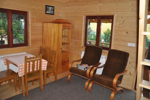 a room with a table and chairs in a cabin at Porębówka in Szczawnica