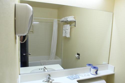 baño con lavabo y espejo grande en Budget Inn Anaheim near Disneyland Drive, en Anaheim